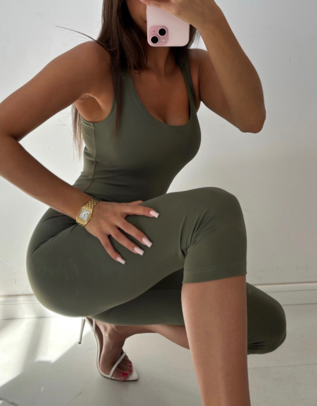 Liv khaki capri jumpsuit with scoop neckline, seated mirror view