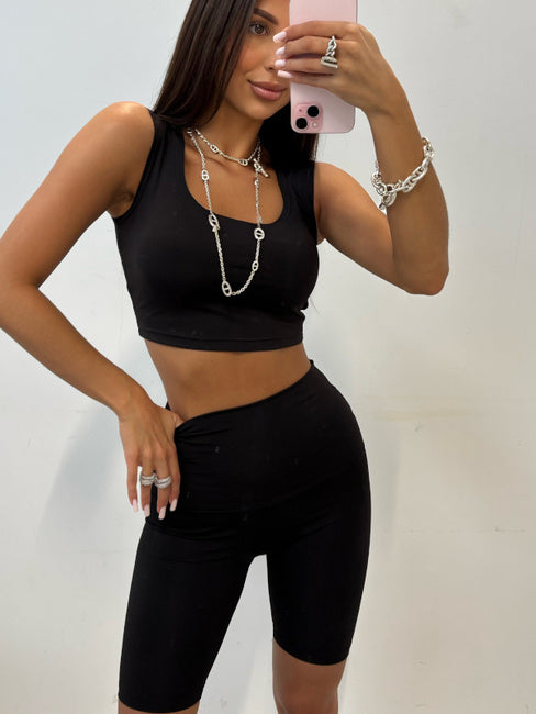 Klara black high-waisted cycling shorts styled with a black crop top, close-up