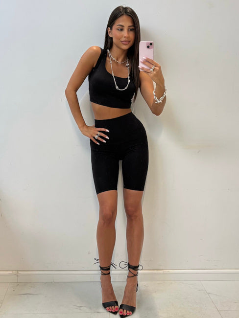 Klara black high-waisted cycling shorts styled with a black crop top and heels